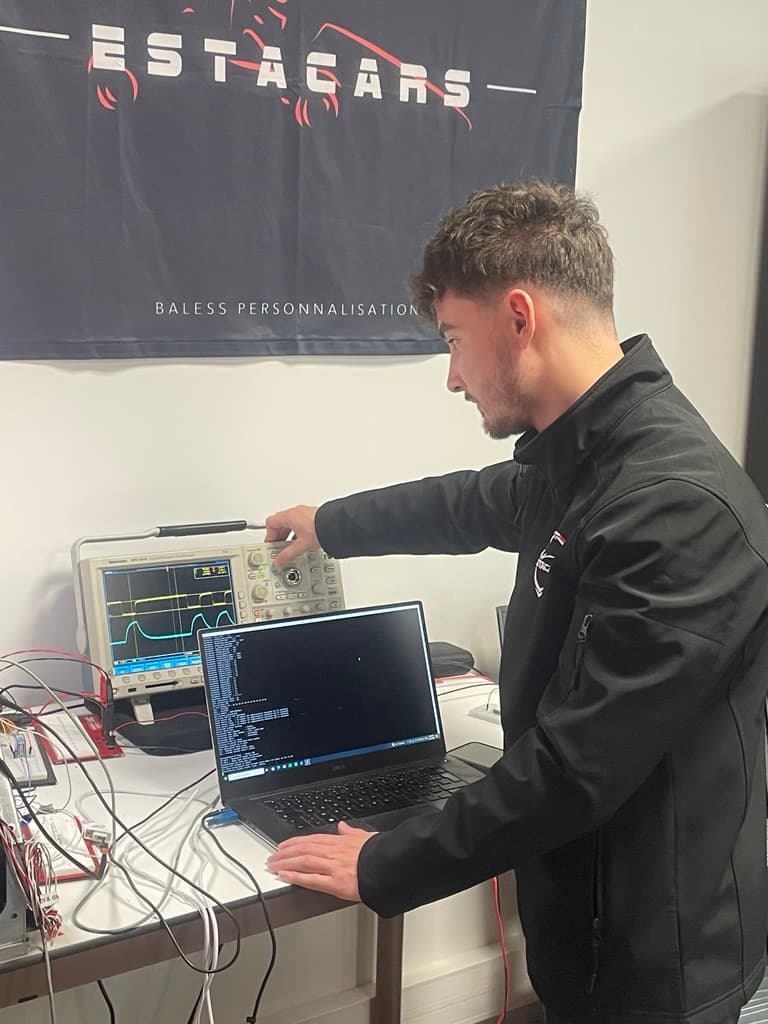 Engineer validating the filtered RS-485 communication with an oscilloscope and BMS logs