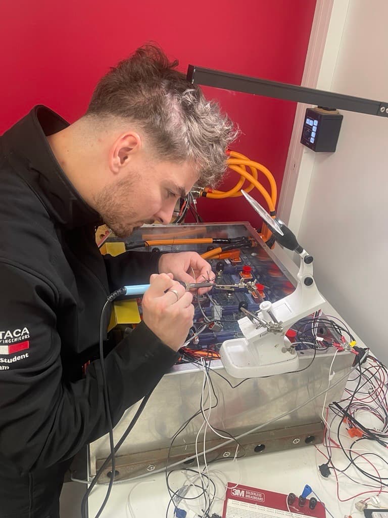 Engineer soldering the RC filter inside the accumulator